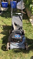 Front view of the Murray ProSeries Quantum 6.75 gas lawn mower with grass bag attached, showing overall structural and cosmetic condition.
