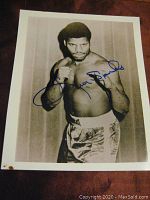 Full view of signed 8x10 photograph of Leon Spinks in boxing pose