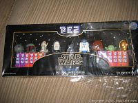 Box showing entire set of approximately 9 Star Wars PEZ dispensers in original packaging with visible Star Wars and PEZ logos