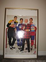 Framed store display poster showing Doug Gilmour holding Doritos, Kirk Muller holding Ruffles, Don Cherry in red plaid jacket, all three on ice rink background with signatures at bottom right corner and NHLPA logo.