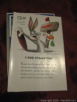 Close-up photo of the Bugs Bunny stamp booklet pane showing Bugs Bunny holding a mailbox and Daffy Duck