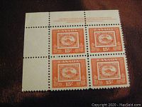 Four orange Canadian 15 cent Threepenny Beaver stamps in block of four with top perforated margin and centennial Canadian Bank Note imprint text.