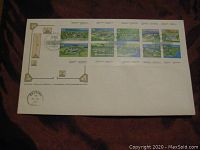 Photo of the full First Day Cover envelope showing all 10 booklet stamps with detailed Fort illustrations, postmarked in Selkirk, MB, 1985.