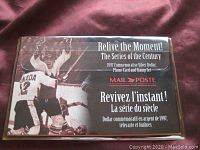 Photo of the display package for the 1997 commemorative silver dollar, phone card, and stamps.