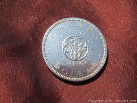 Reverse side of coin showing floral motif and inscriptions "CANADA DOLLAR 1864 CHARLOTTETOWN 1964".