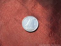 Obverse side of the 1951 Canadian dime showing the Bluenose sailing ship and date '1951'.