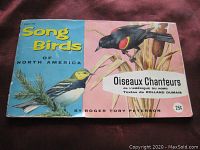 Front cover of 1959 Song Birds of North America album by Roger Tory Peterson with colorful bird illustrations and bilingual title text.