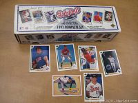 Photo of 1991 Upper Deck factory box labeled '1991 Complete Set' with several cards laid out around it