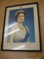 Framed vintage 1953 portrait print of Queen Elizabeth II showing full front view of framed portrait.