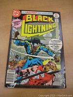 Front cover of Black Lightning #1 comic book showing Black Lightning fighting a character with a metal pipe in an urban setting. DC Comics branding visible.