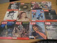 12 LIFE magazines laid out showing covers with various subjects and dates.