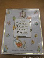 Front cover of the hardcover book titled 'The Complete Tales of Beatrix Potter' with illustrations and gold embossed text.