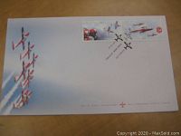 White envelope showing an aerial formation of Canadian Forces Snowbirds planes and two stamps in the top right corner.