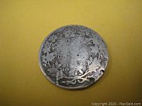 Reverse of 1919 Canadian 25 cent coin with denomination, date and wreath design, showing the clamshell split planchet error