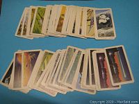 Top side of the partial set of Brooke Bond Red Rose Tea collector cards showing colorful illustrations including animals and space themes.