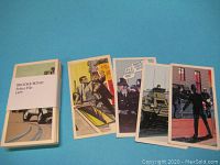 Photo showing the bundled set of Brooke Bond Police File cards and several cards laid out face-up illustrating the colorful police-themed artwork.