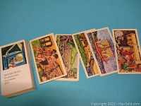 Photo shows several Brooke Bond Inventors & Inventions cards laid out face up and face down, displaying colorful illustrations and text backs.