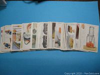Full set of vintage cigarette cards from 1936 laid out in fan shape showing various household hint illustrations.