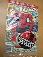 Front cover of Spider-Man #1 comic book sealed in plastic. Shows comic's title, collector's item sticker, art of Spider-Man crouching.