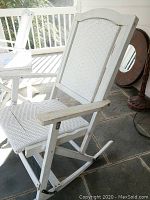 White wooden rocking chair with woven seat and backrest, showing overall form and materials.