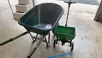 Wheelbarrow and seed spreader side by side showing overall condition and size comparison.