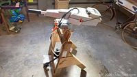 Torqeedo Travel 1003 electric outboard motor mounted on wooden stand in garage