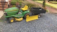 Side view of John Deere LT155 tractor, mower deck, utility cart and snow blade