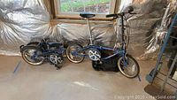 Two folding bicycles side by side, one folded and one assembled