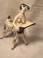 Front view of the ceramic sculpture showing full composition