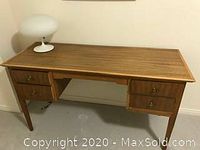 Front left perspective view of desk with lamp on top