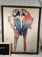 Full view of framed artwork showing two colorful parrots and signature