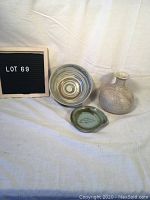 Photo showing all three pottery pieces together on a light cloth background for scale and condition