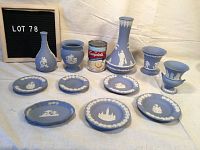 Overview of all 11 Wedgwood jasperware pieces arranged on fabric background, includes vases, urns, and 6 plates/dishes.