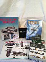 Five hardcover books on wartime aircraft arranged on a surface. Titles visible include Battle of Britain and Spitfire II The Canadians.