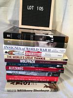 Stack of 13 hard cover military and war-themed books with visible spines showing titles and authors.