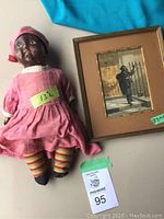 Framed Baxter print and antique doll side by side showing size and condition.