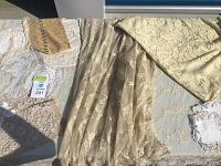 Various vintage lace textiles spread out on a flat surface showing texture, patterns, and colors.