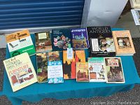 Full view of all 14 books arranged on table, showing titles and cover designs related to antiques and furniture collections.