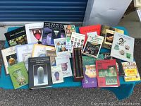 Overview of 24 collector's books spread out on a table, showing covers of various titles related to glass, antiques, and collectibles.