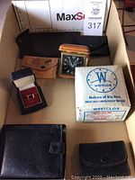 Overview photo of the 7 men's items including clock, boxes, wallets, and pouches.