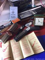 Photo of the lot showing King Cutter razor case, Old Pal Cleaners tin, Tilley wallet case, Fisher clock, wooden pipe, and some printed instructions.