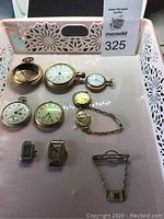 Tray of nine watches and fob showing overall assortment