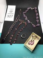 Full lot on black background showing necklace, bracelet, ring and boxed earrings.