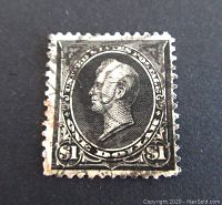 Front image of one used 1895 US $1 black postage stamp showing left-facing portrait with broken circle cancellation and worn perforations.