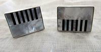 Pair of rectangular cufflinks with piano key motif in mother of pearl and onyx inlays seen from the front.