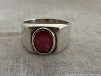 Front view showing broad sterling silver band and faceted oval ruby set on top