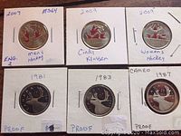 Six Canadian quarters, three from 2009 hockey series and three proof coins from early 1980s, secured in holders with handwritten labels.