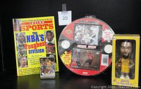 Photo showing basketball collectibles including the Inside Sports magazine, Michael Jordan Air Slammin' kit, Derek Fisher 2004 Lakers bobblehead doll in box, and a stack of trading cards. All items in good condition.