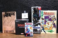Photo showing the full Avengers collectors lot including two comic books (1966 and 1993 issues), Marvel 3D Comic Standee Captain America in box, Ronin action figure in box, and Avengers Alternate Visions comic book.
