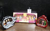 Wide shot displaying all three PEZ gift sets: Disney Princess box, Angry Birds tin, and Star Wars Millennium Falcon tin on table.